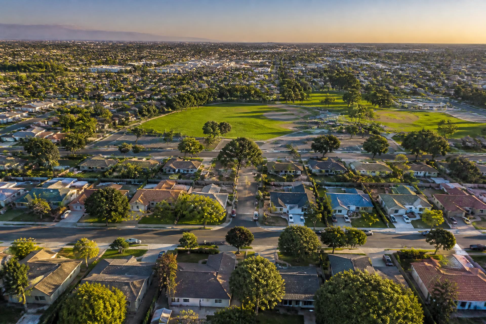 Aerial view of tree-lined Fountain Valley neighborhoods at golden hour